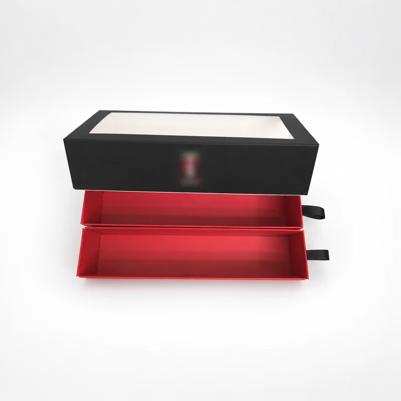 Double drawer box with two red trays pulled out below the black window sleeve